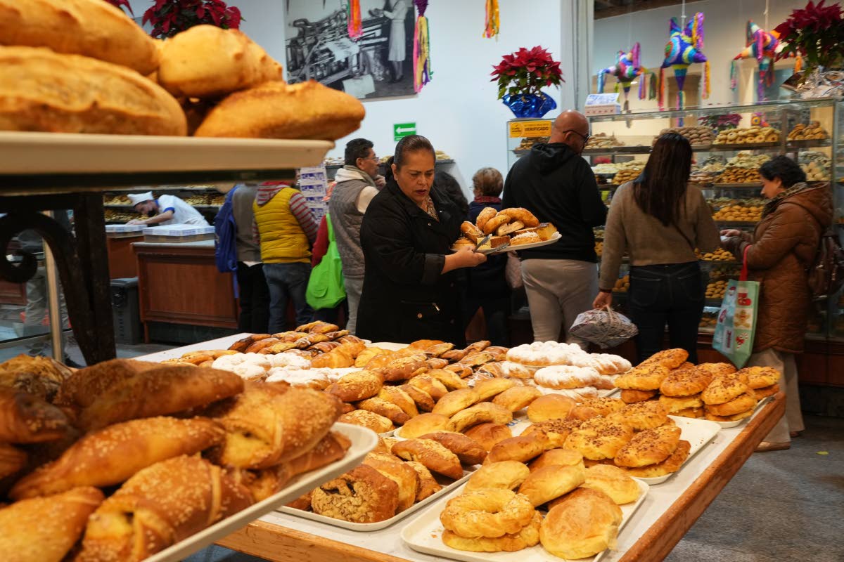 People buy pastries at a bakery in Mexico City, Thursday, Dec. 18, 2025. 