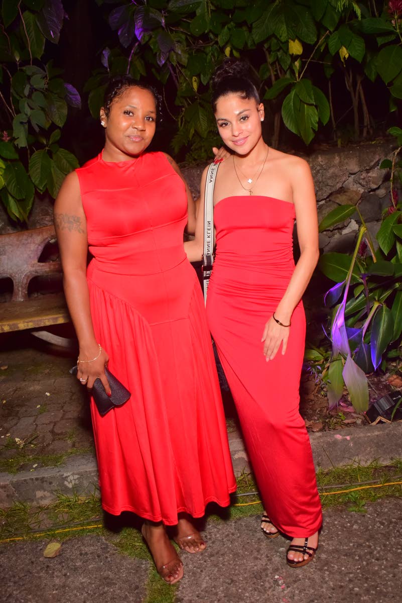 Ladies in red Tia Bramwell (right) and Shian Outar soak up the night’s atmosphere.