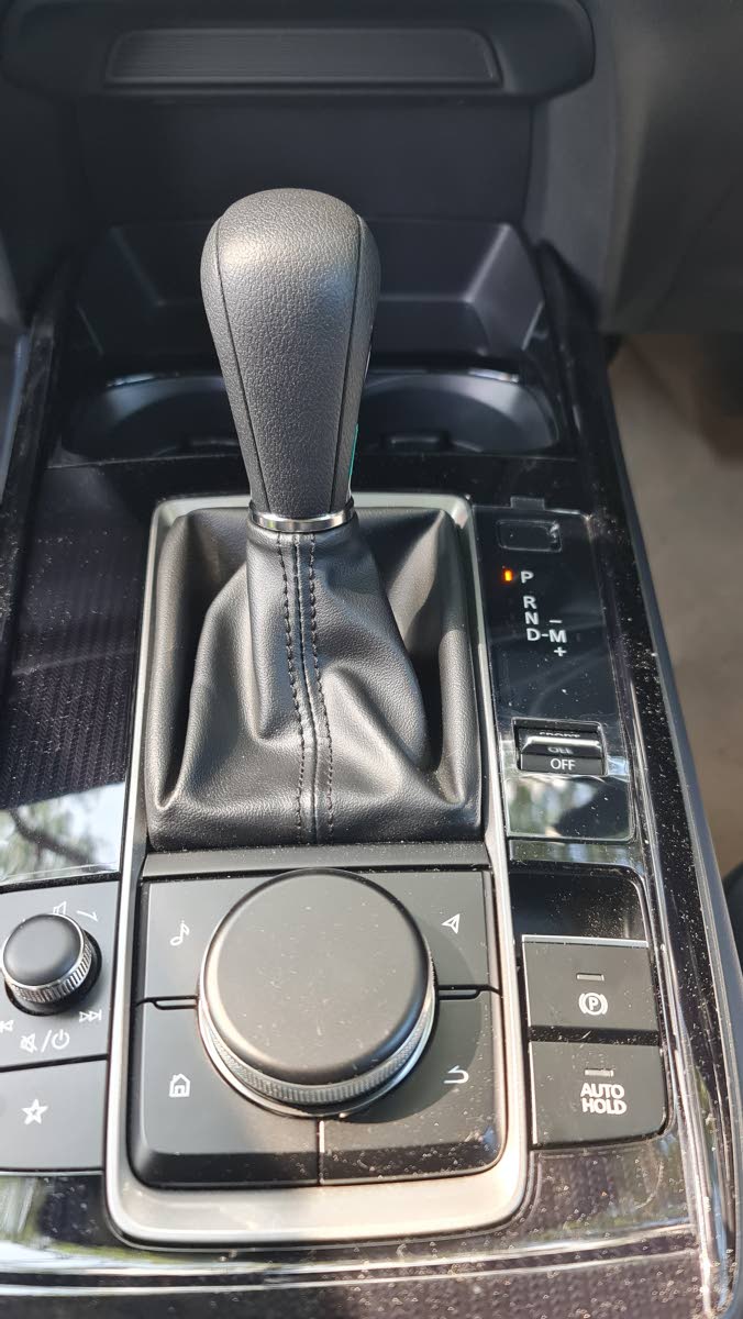A closer look at the gear selector and surrounding controls highlights the high-quality materials and intuitive placement of the rotary multimedia commander.