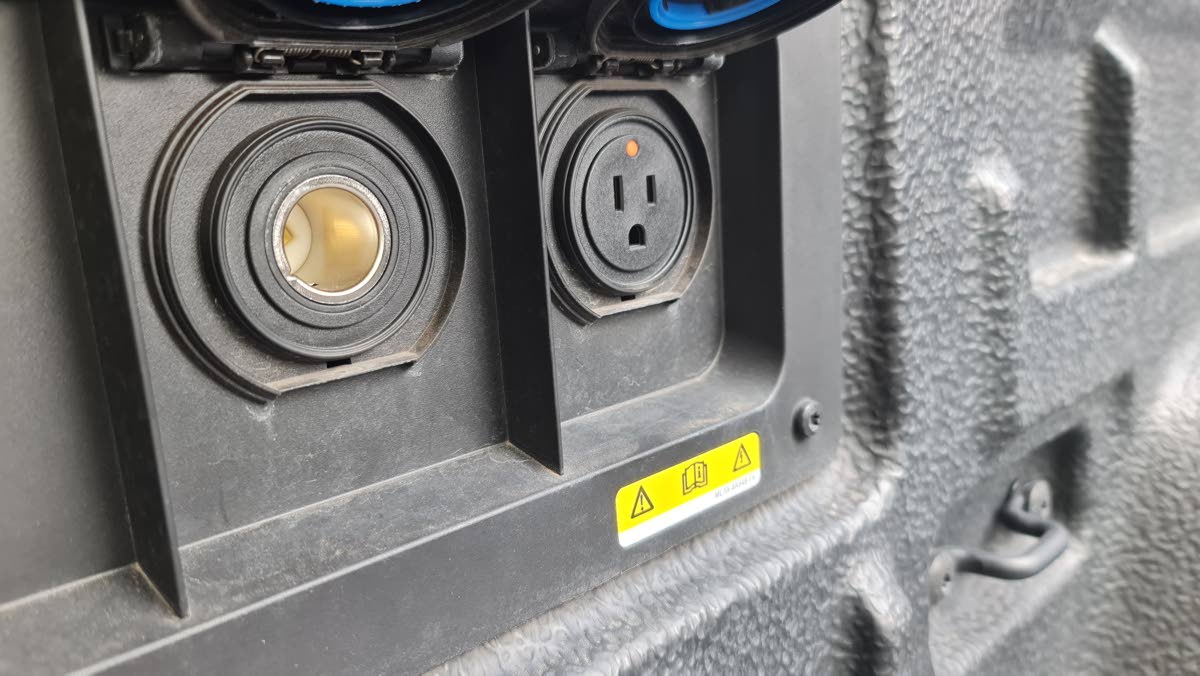 There are two 110 V sockets in the bed. 