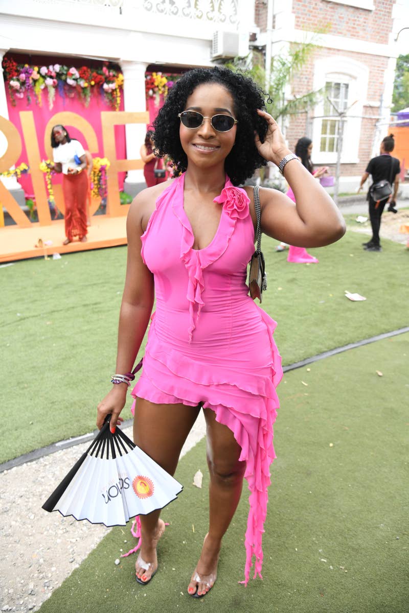 Partygoer Cristal Holness struts the Campion College lawn in a pink crush ruffles and roses mini dress from Fashion Nova.