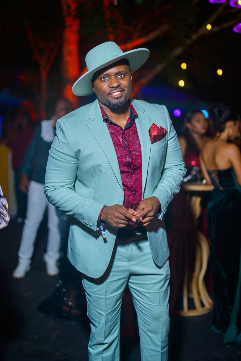 Attorney-at-law Clayton Lawrence dons a blue suit from Express and a matching fedora, with a deep burgundy shirt.