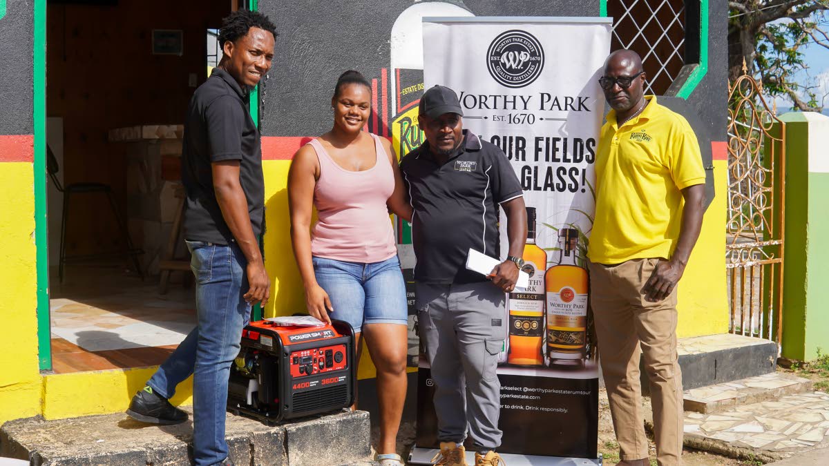 From left: Janoi Cunningham, Moniefie McDonald, Oneiko Green and David Dixon with a generator donated by Worthy Park at Lacy’s HQ, Lacovia, St Elizabeth.