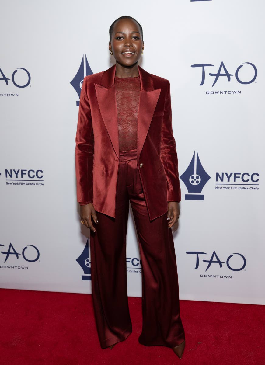 Lupita Nyong’o wears a Alicia + Olivia by Stacey Bendet Silas velvet blazer, Taeeyn lace bodysuit and Kennedy trousers to the New York Film Critics Circle Awards at Tao Downtown on Tuesday, in New York. 