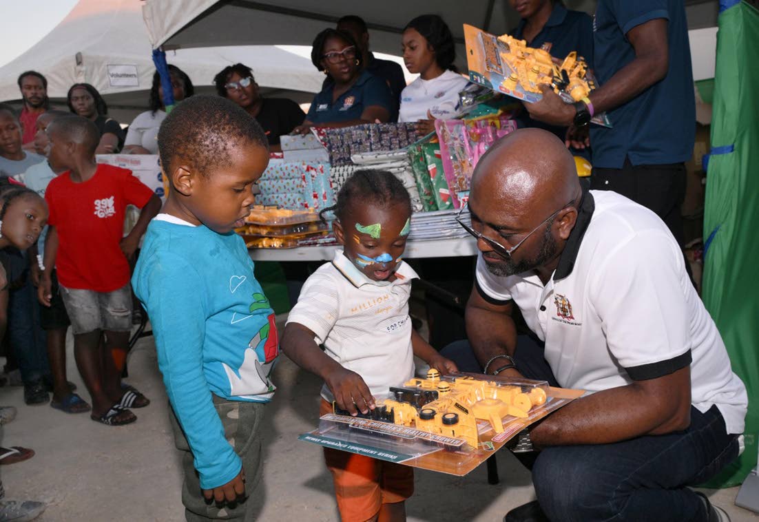 Dr Andrew Wheatley, hands out gifts to children.