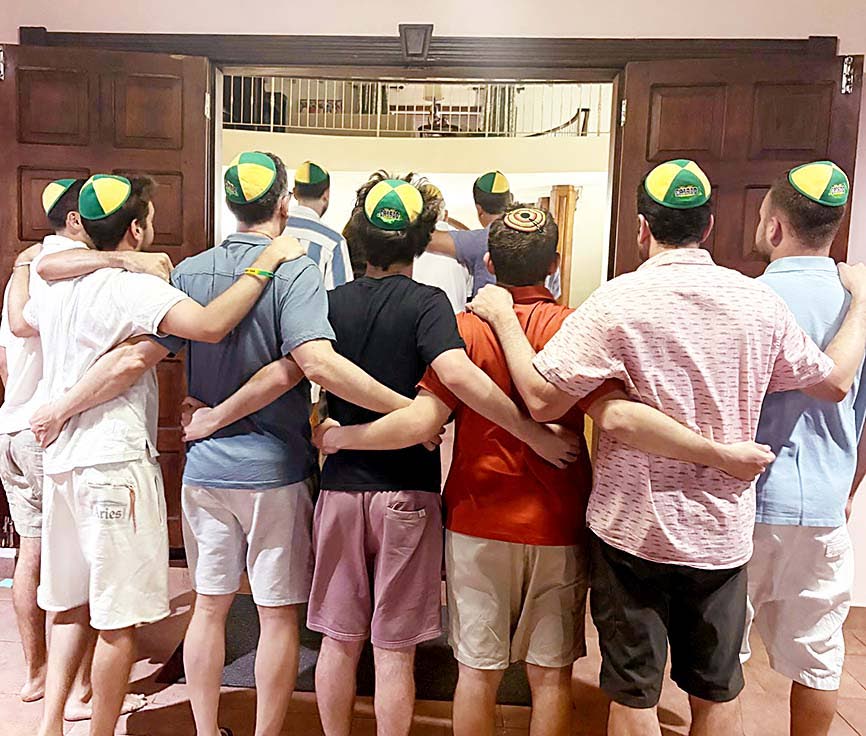 A local family not just existing, but truly living, celebrating Shabbat, proudly wearing the famous Chabad Jamaica kippah.