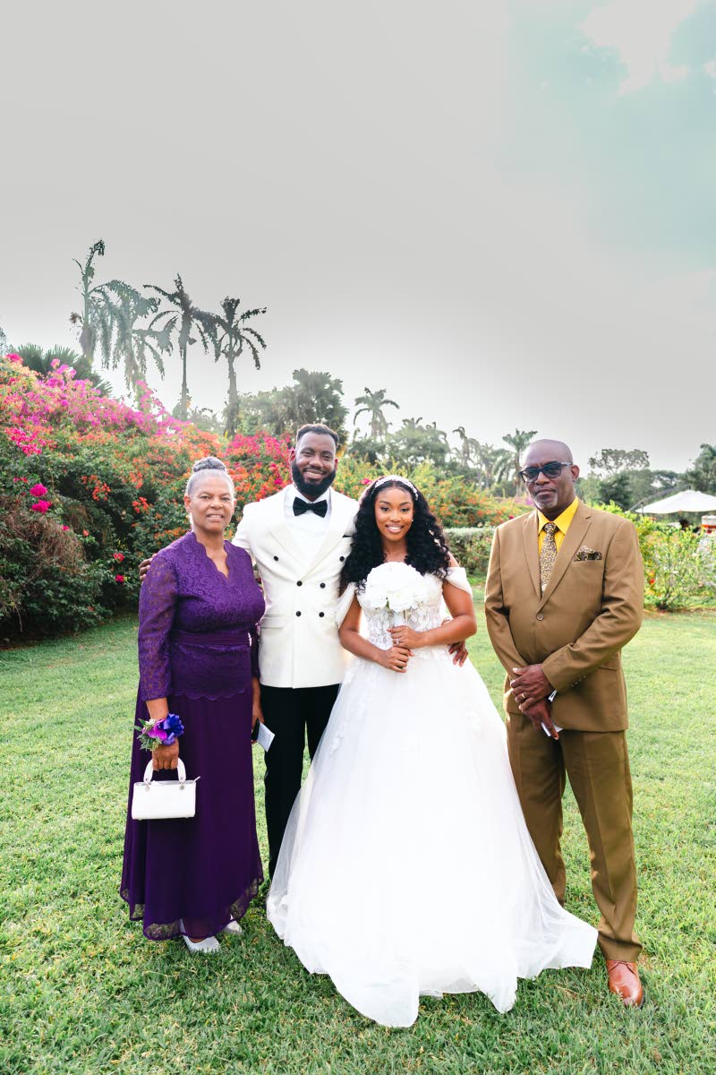 Adriel (second left) and Danielle share a joyful moment with the bride’s parents, Norma Reid (left) and Pastor Dwight Reid. 