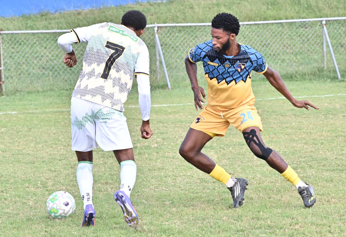 Racing United’s Andrew Campbell (right) tries to stop Treasure Beach’s Karim Bryan during a Jamaica Premier League football game at Ferdi Neita Park yesterday. Racing were 4-1 winners.