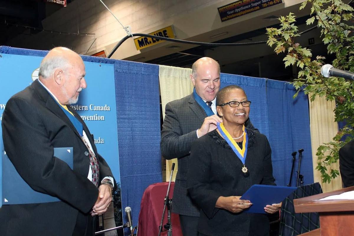Hope Markes (right) receiving the Mel Osbourne Fellowship for her election to district governor from Kim Conrad, past president of the Kiwanis Foundation of Canada. Sharing in the occasion is past Governor Chuck McIIravey. 