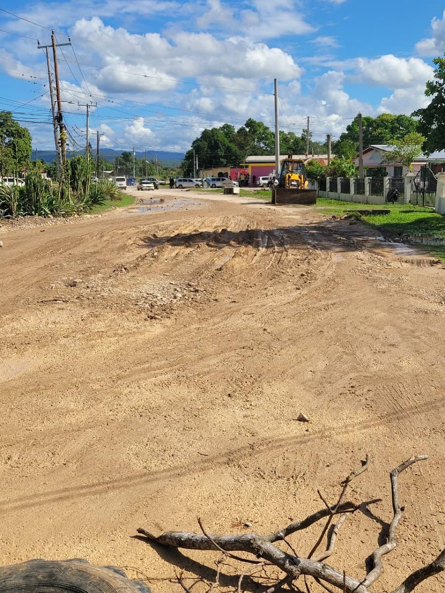 Mud‑filled road surfaces in Clarendon.
