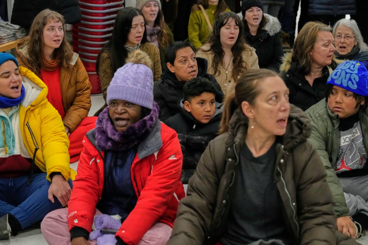 Community members and neighbours of people detained by ICE sing during a protest at a Target store, Monday, January 19, 2026, in St Paul, Minneapolis. 