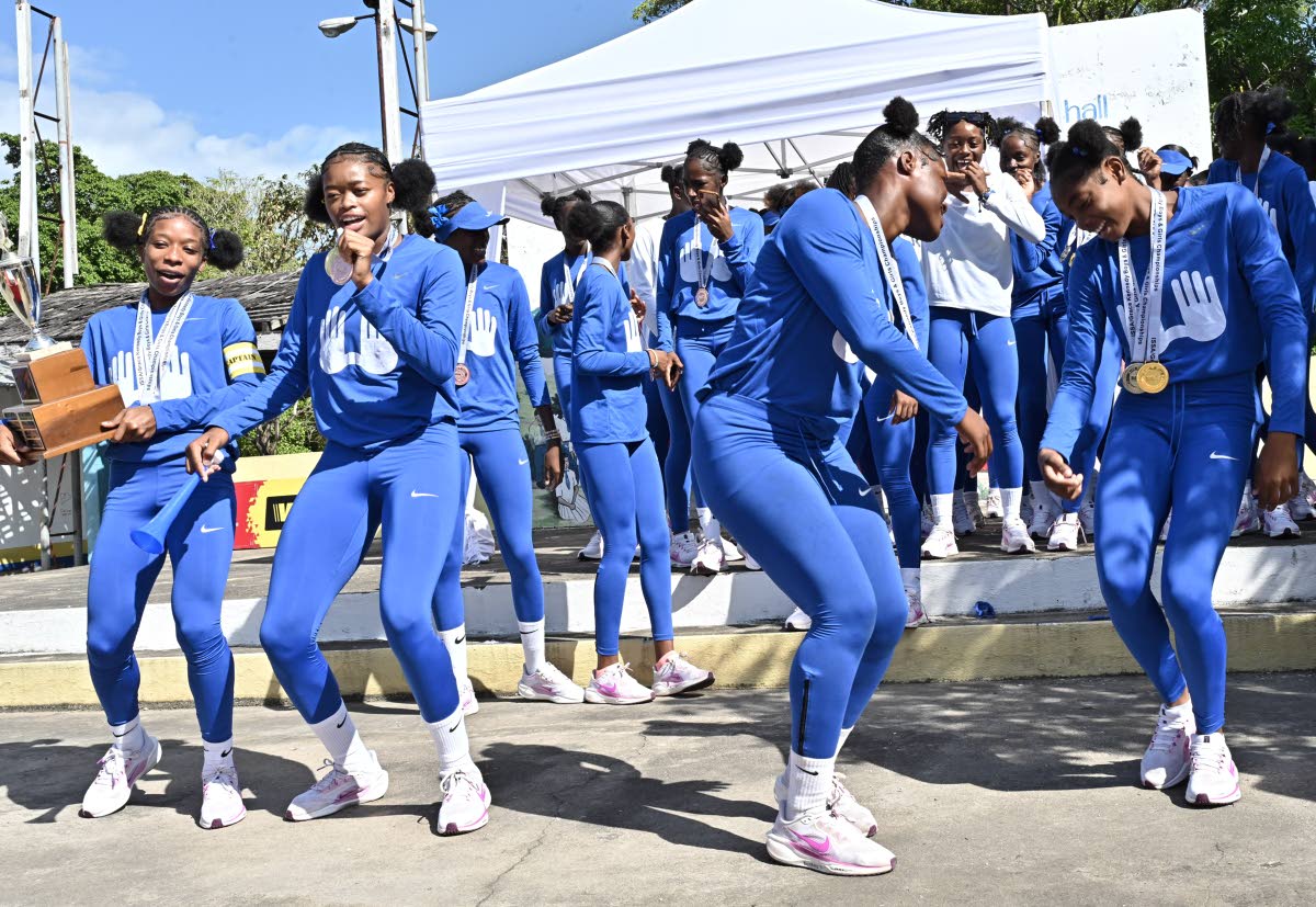 Hydel High School athletes celebrate winning the ISSA/GraceKennedy Boys and Girls’ Athletics Championships girls’ title at the school in March of 2025. 