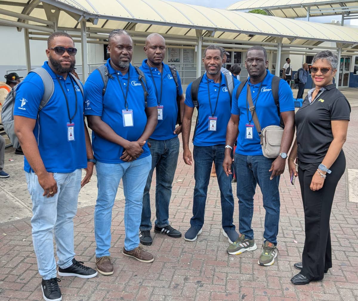 A crew of linemen from Barbados pause for a moment, shortly after arrival in the island to assist with electricity restoration.