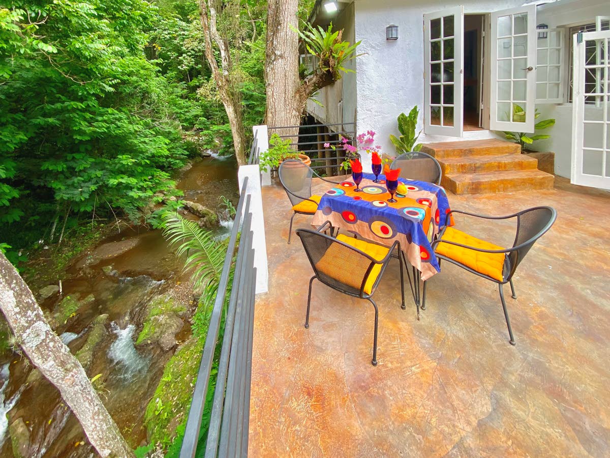 Various covered and open outdoor elevated decks directly overlook the river.