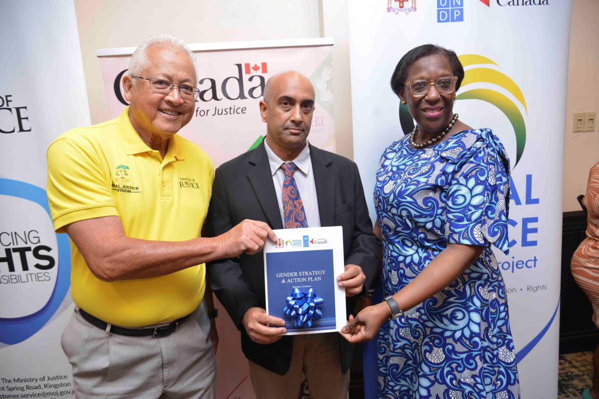Khoday (centre), Justice Minister Delroy Chuck and Sharon Coburn Robinson, acting senior director, Bureau of Gender Affairs, hold a copy of the Gender Strategy and Action Plan during the handover ceremony for Jamaica’s Gender Strategy & Action Plan for t