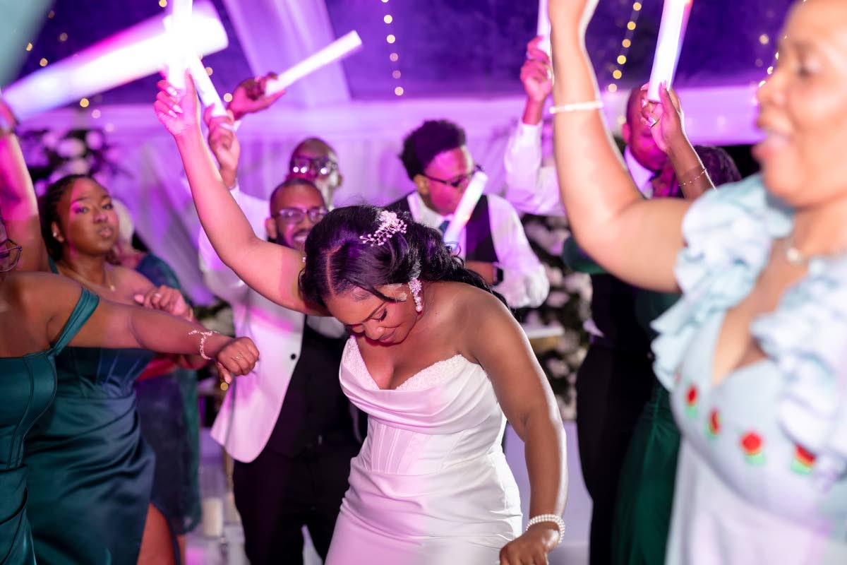 Jilaine takes to the dance floor as guests cheer and celebrate during the reception.