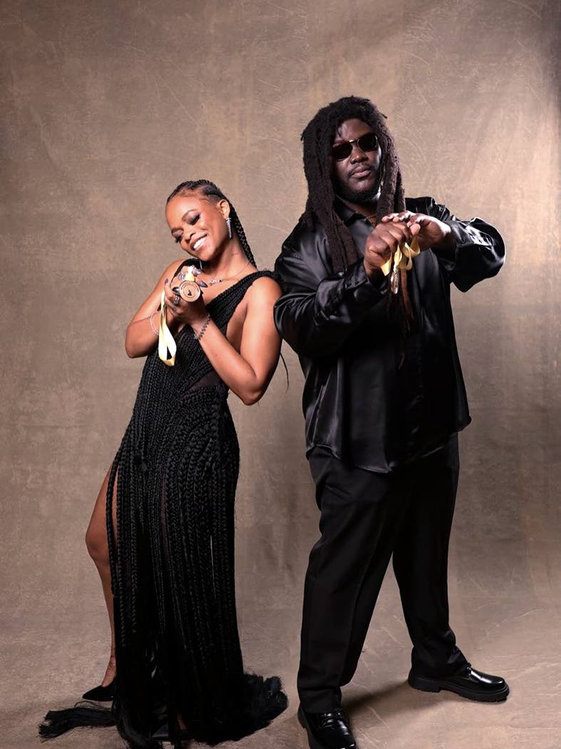 Lila Iké and Mortimer show off their Grammy medals at the official Grammy Nominees Reception on Saturday night.