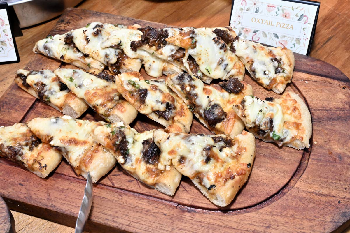 The oxtail pizza layers braised oxtail and melted cheese on a baked crust.