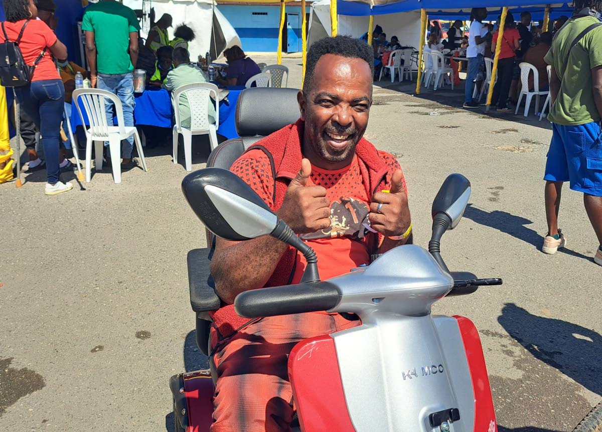 Patrick Rhoden of Old Harbour, who uses a motorised wheelchair, attends the Ministry of Justice Legal Aid Council Justice Fair for Persons with Disabilities.
