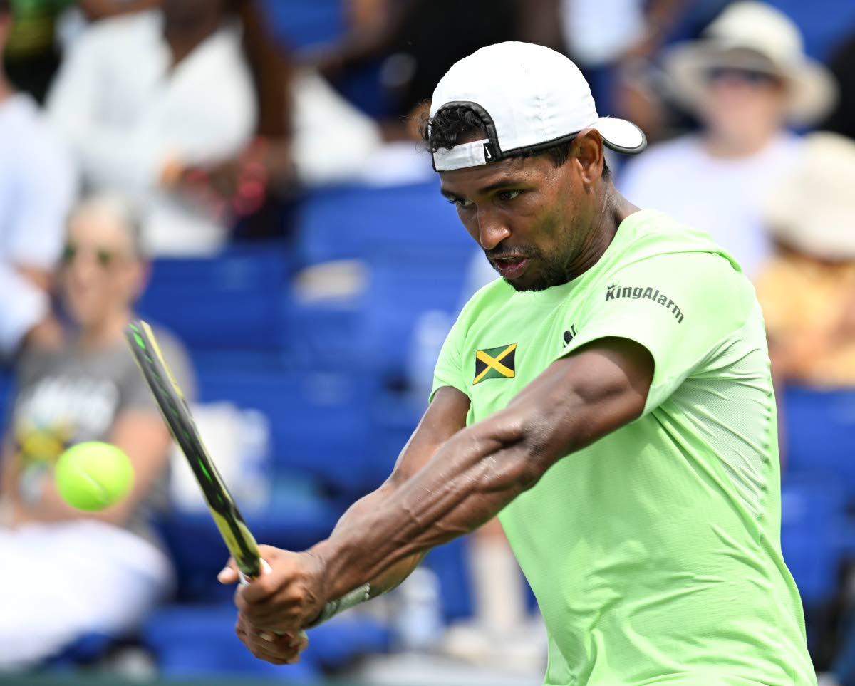 Jamaica’s Rowland Phillips plays a backhanded return during Davis Cup Group II action at the Eric Bell Tennis Centre in 2024.