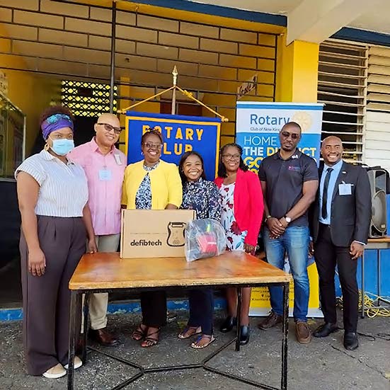 Rotary Club of New Kingston District Governor William Aiken (second from left) and president Alex Robinson (far right), joined by Vice‑Principal of Constant Spring Primary and Infant School Michelle Wiggins (fifth from left), during the handover of an AE