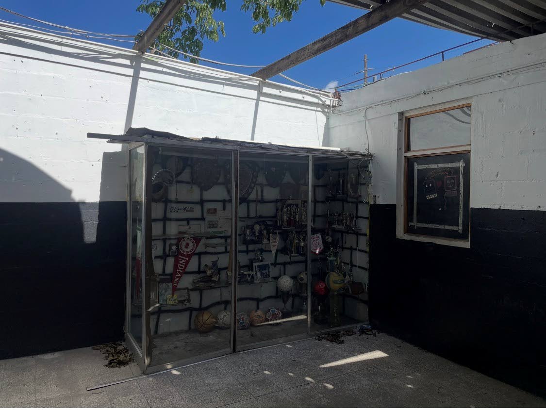 The trophy cabinet, which housed pictures and trophies  won over several decades, is now in ruin.