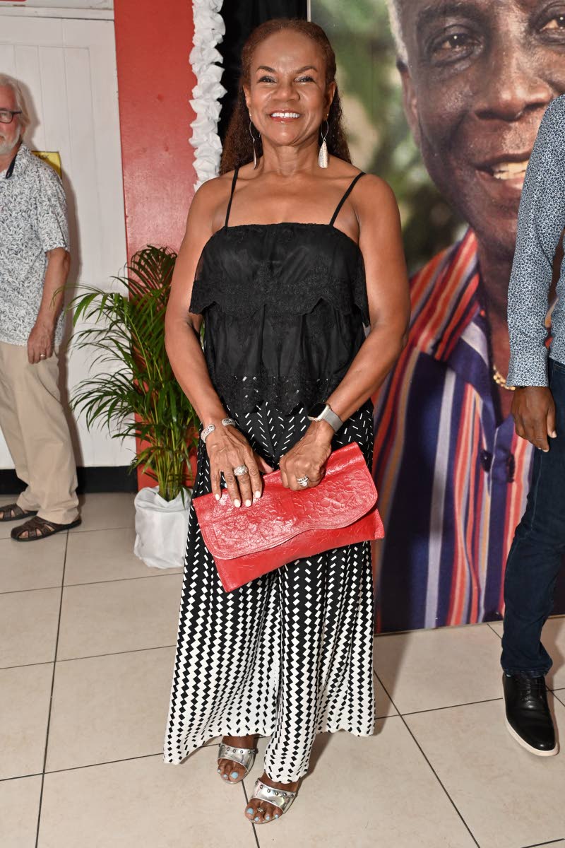 Above: Rosemarie Voordouw, associate counselling psychologist, brightens her monochrome maxi with a bold red clutch.