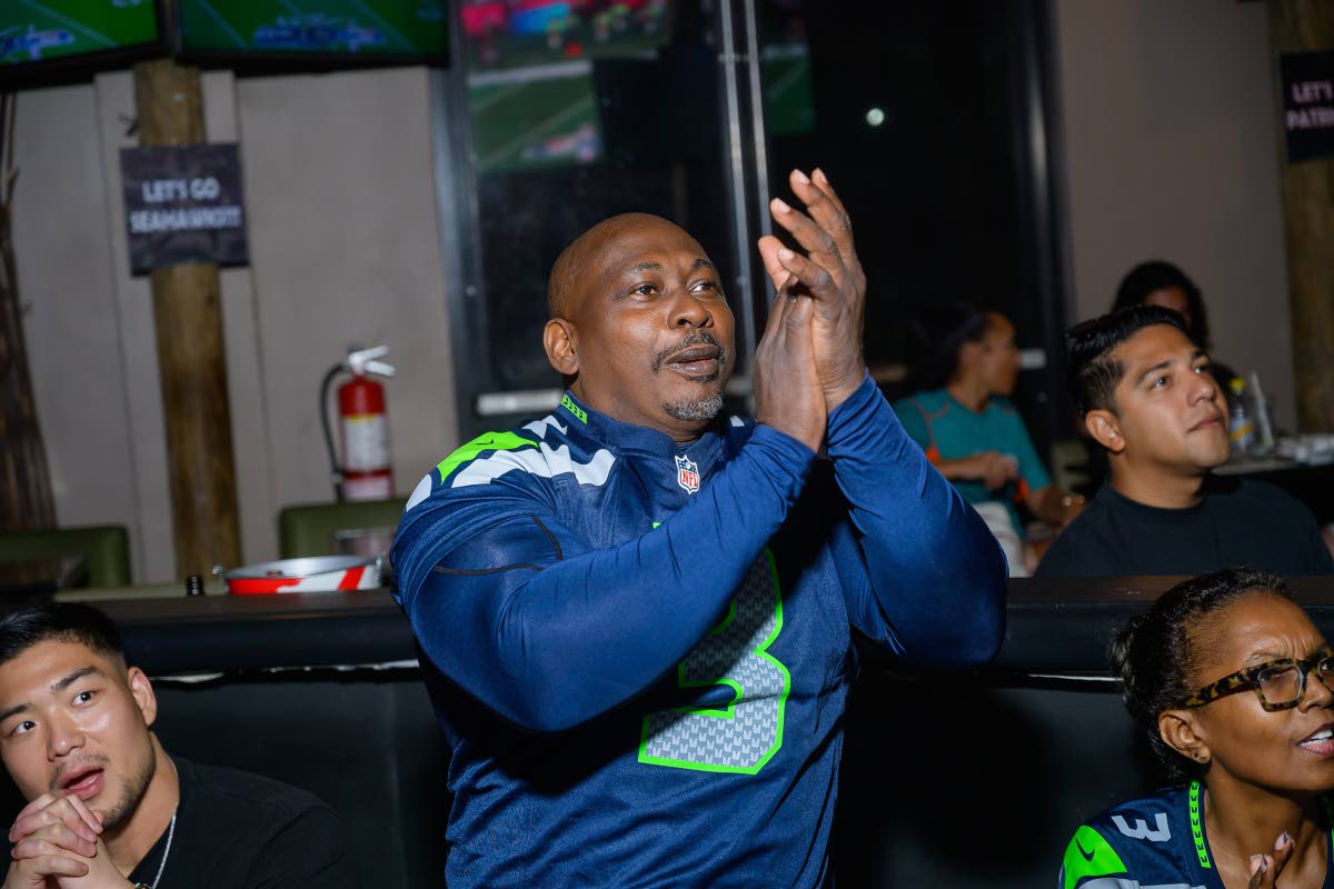 Kerniffe Lugg, electronics engineer and Seahawks fan, applauds as a key play lights up the screens.