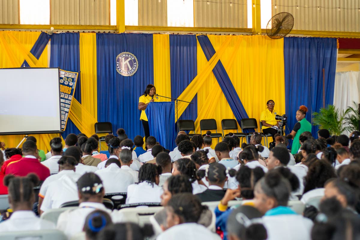 An executive member of the Kiwanis Club of Linstead addresses students at the college fair. 