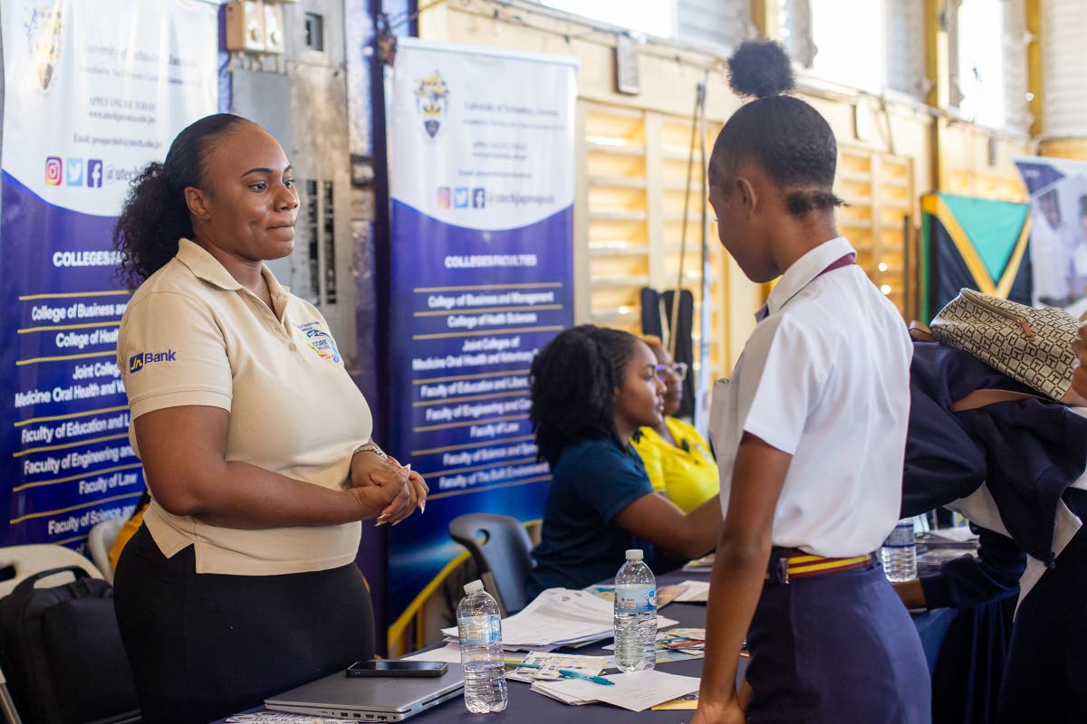Students engage with exhibitors at the Kiwanis Club of Linstead College Fair.