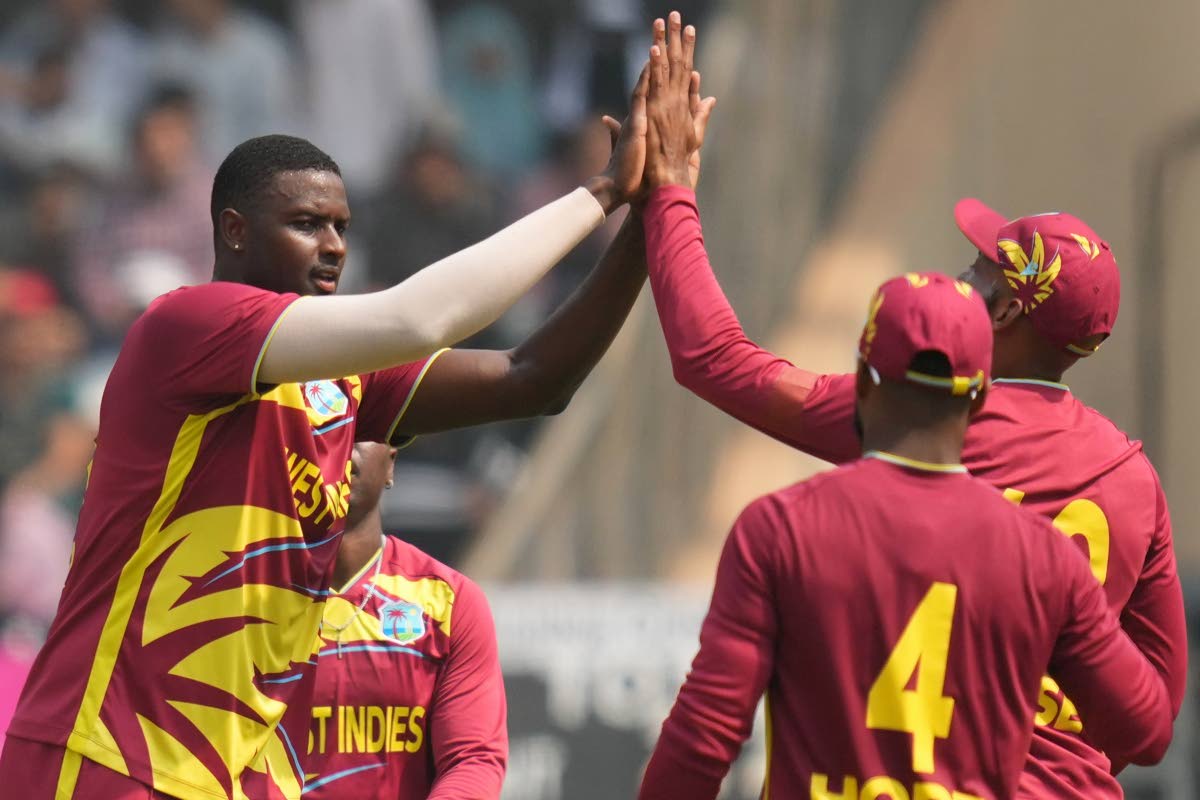  West Indies’ Jason Holder (left) celebrates with teammates after dismissing  Nepal’s Aarif Sheikh during the T20 World Cup cricket match against Nepal in Mumbai, India, on February 15.
