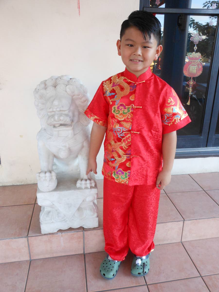 A young member of the Chinese community celebrates the New Year in red to welcome good fortune.