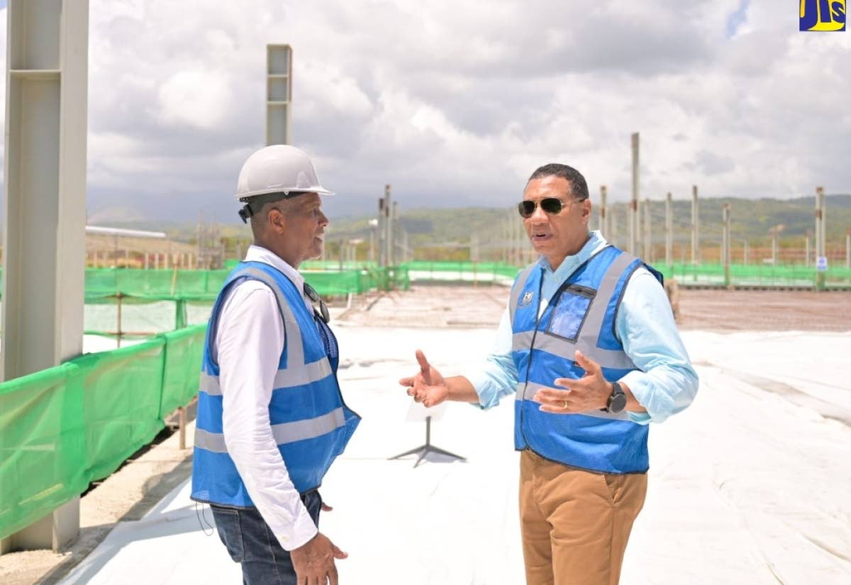 Prime Minister Dr Andrew Holness (right), speaks with Factories Corporation of Jamaica (FCJ) Chairman, Lyttleton Shirley, during a tour of the Morant Bay Urban Centre in 2024. 