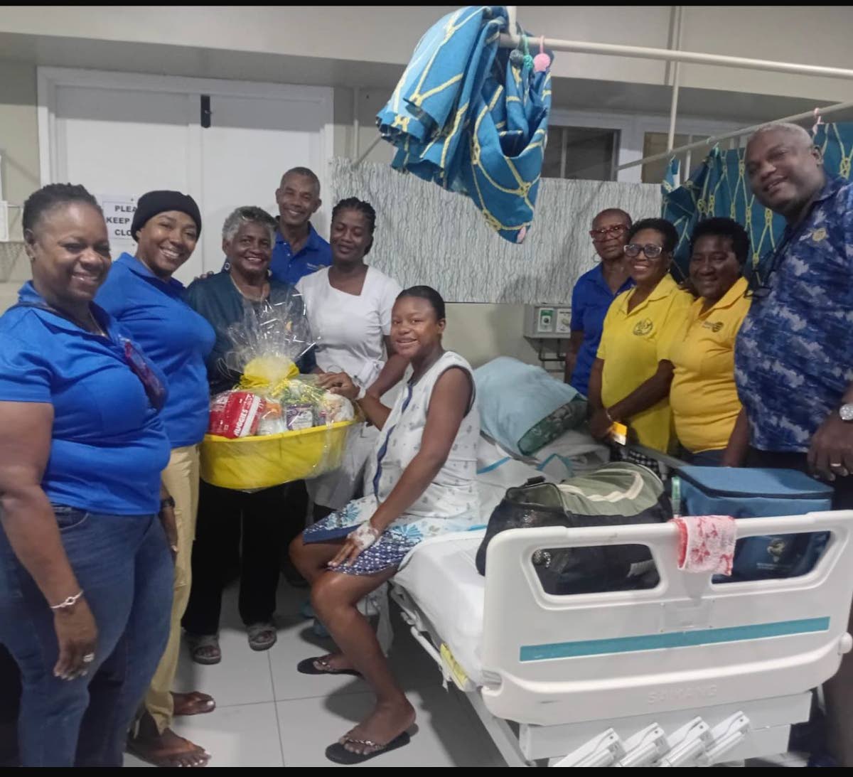 Members of the Rotary Club of Savanna-la-Mar present a hearty gift basket to Nicole Taylor, mother of the first baby girl of the year, Aneila Heaven.