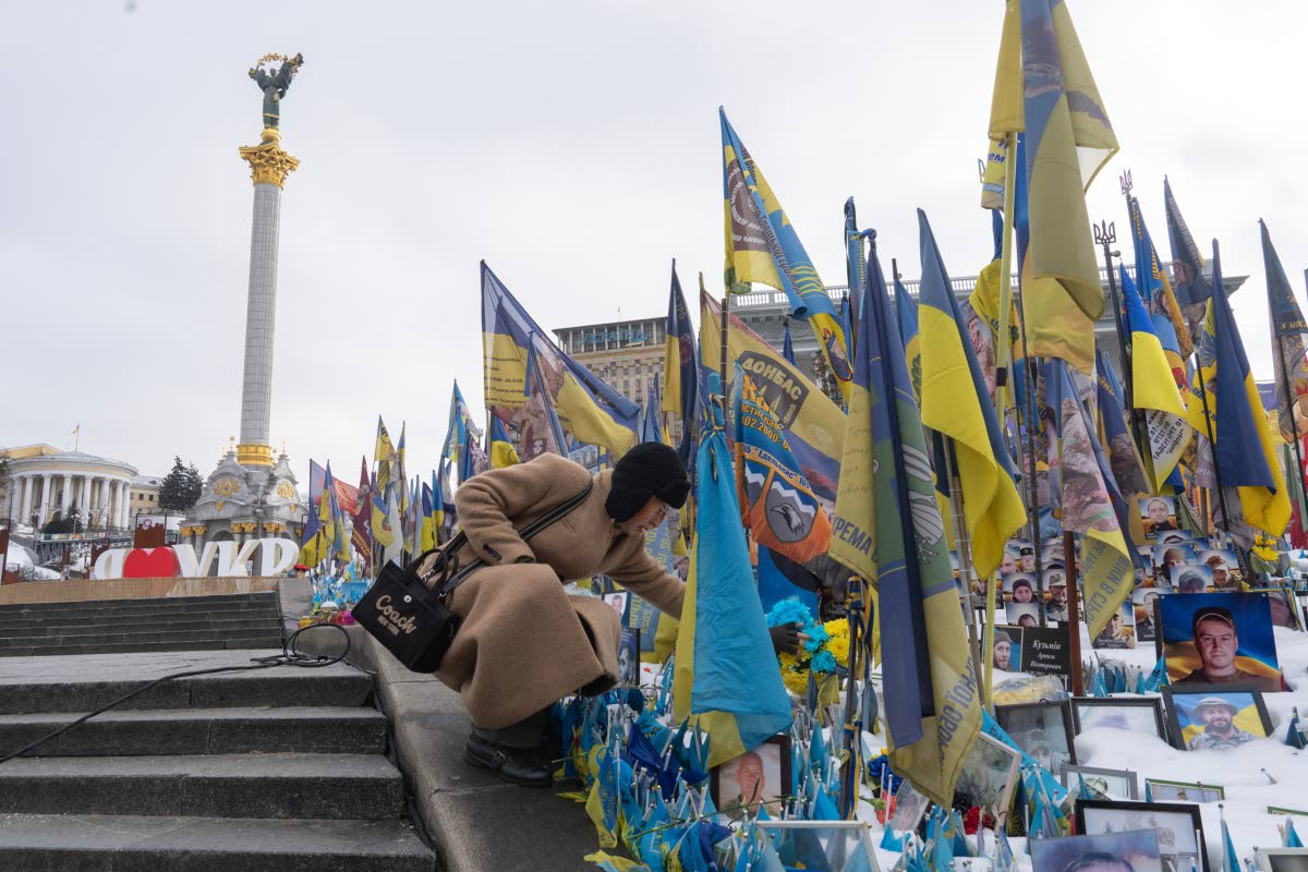 A woman places flowers at the memorial to the fallen Ukrainian soldiers on Independence Square to mark the fourth anniversary of Russia’s full-scale invasion in Kyiv, Ukraine, on Tuesday, February 24.