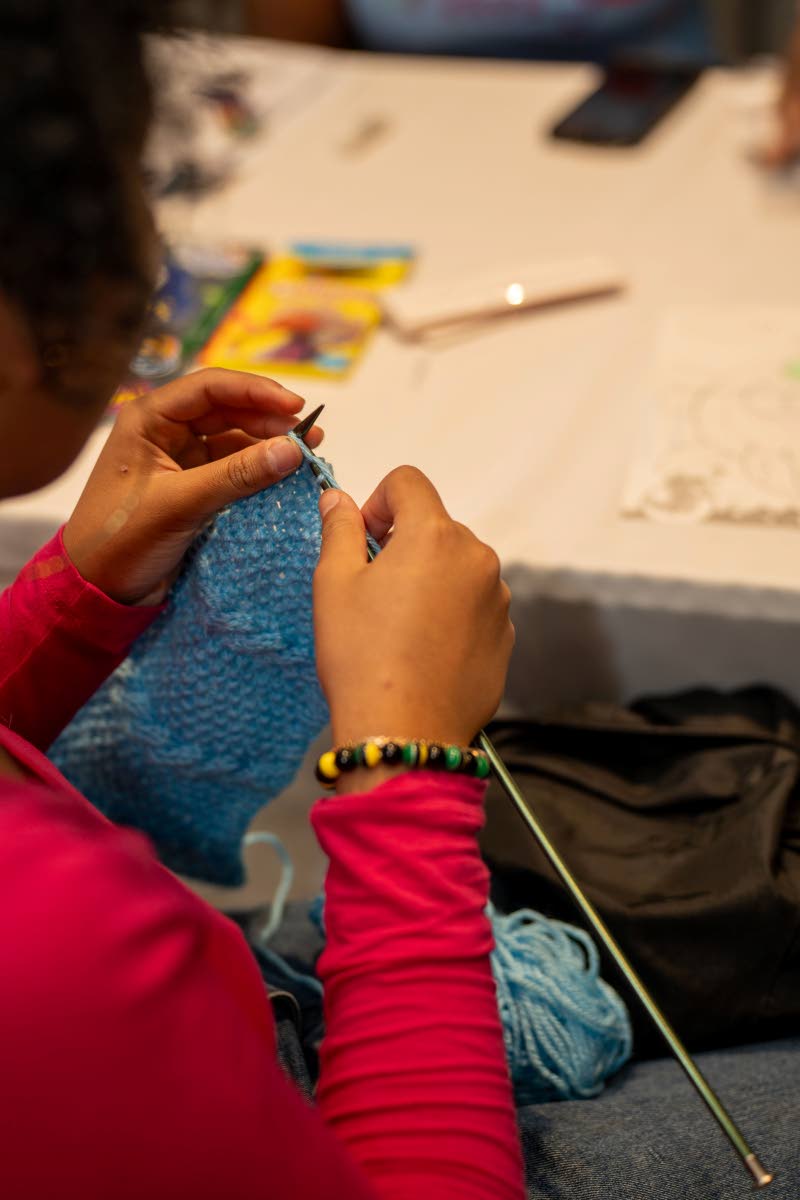 A patron explored knitting while at the Book Fairy Festival.
