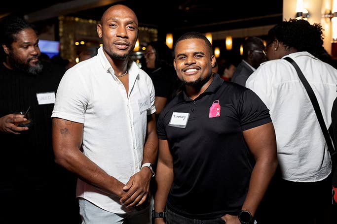 Javae Munroe (left), chief operating officer, M-One Productions, catches up with Timothy Skyers, co-principal, Pink Apron Jamaica.