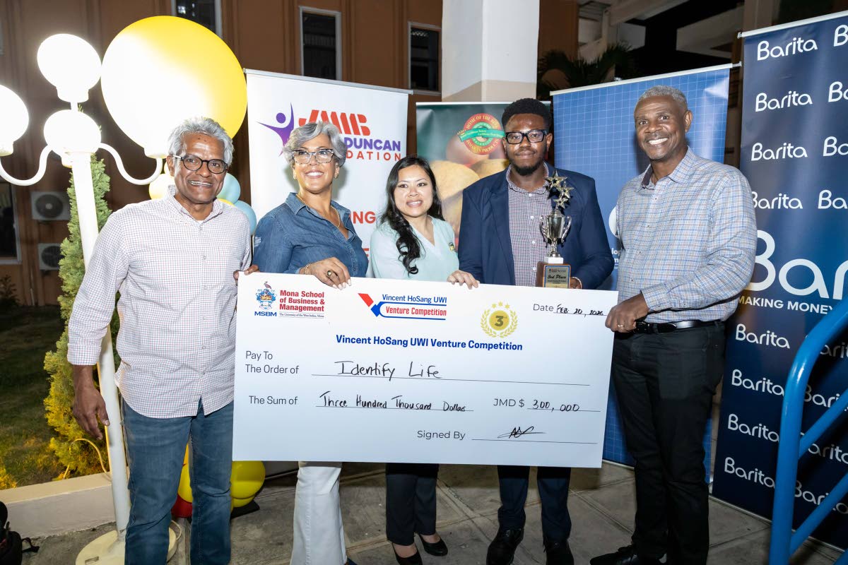 From left: Douglas Lindo, Kim Mair, Simone HoSang, DeAndre Haughton, representing IDentify Life; and Wayne Sutherland, director of the JMMB Group, celebrate IDentify Life’s third‑place achievement at the Finals and Awards Ceremony of the 2025–26 Vinc