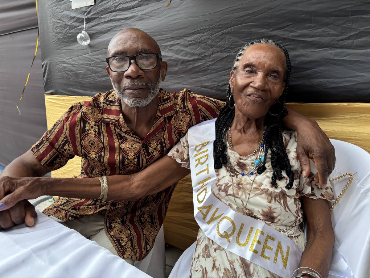 Centenarian Alice Drysdale Stewart sharing a moment with her son, Oswald Edwards, during her birthday celebration on February 21 at The Little Copa in Bull Bay, St Andrew.
