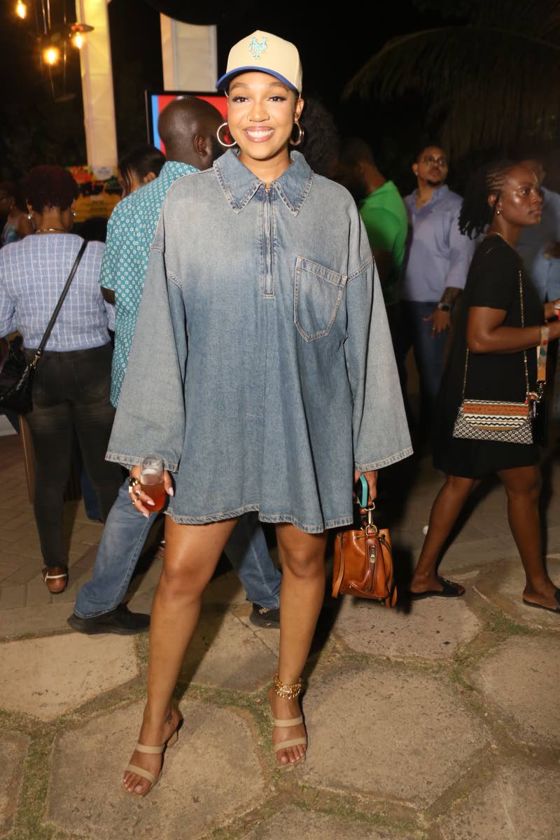 TV host Ashley Miller stepped out in an oversized denim mini paired with a sporty cap and neutral heels, perfect for a night out in Kingston.