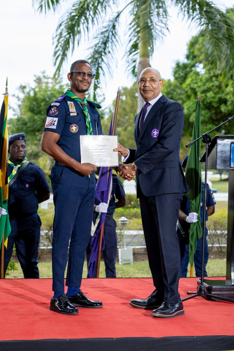Kevin Richards, chief commissioner of the Scout Association of Jamaica, is receiving his warrant from Sir Patrick Allen, governor-general and chief scout of Jamaica. 