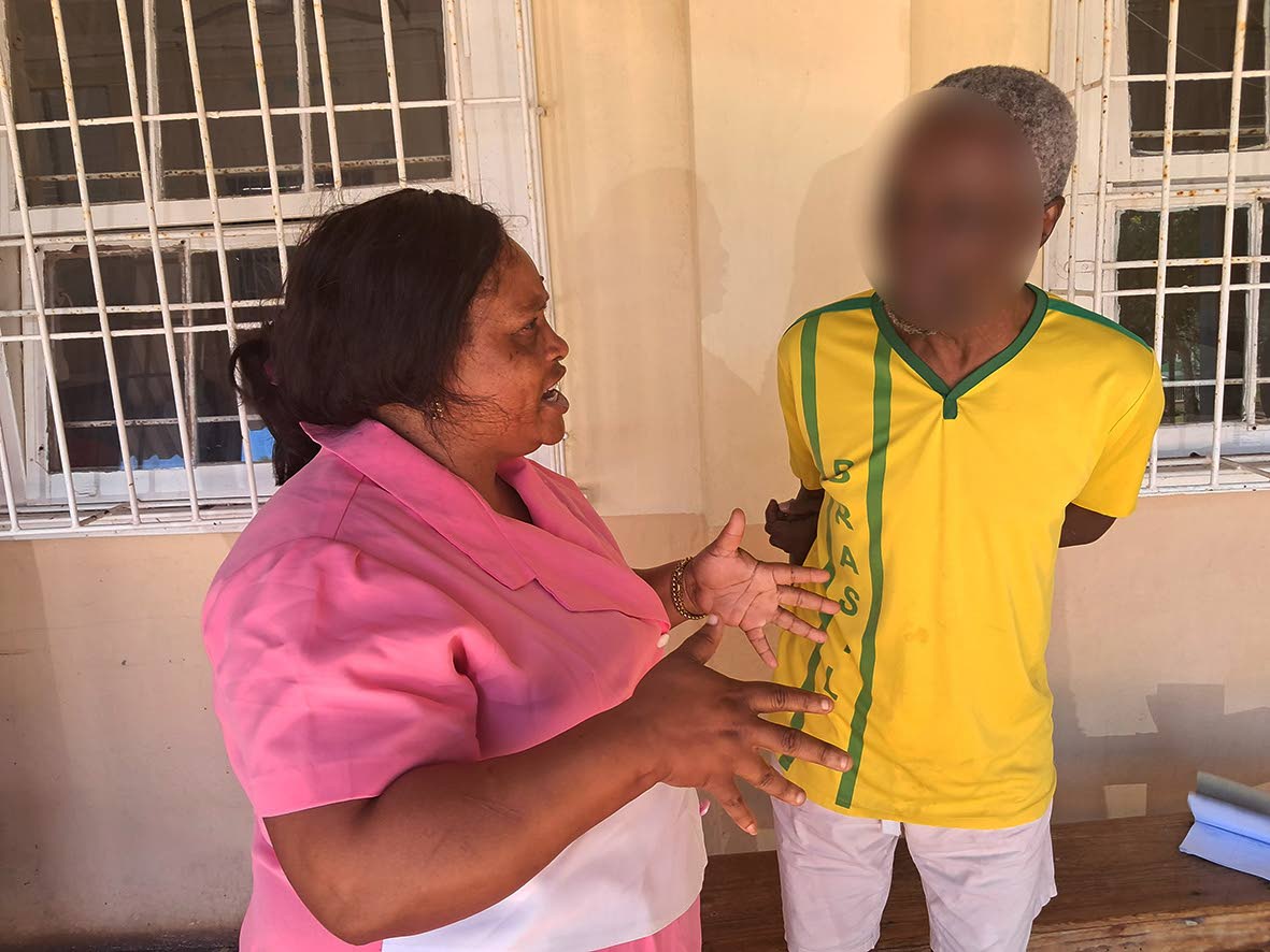 Quadisha Lee, patient care assistant, speaks wth Dempson.