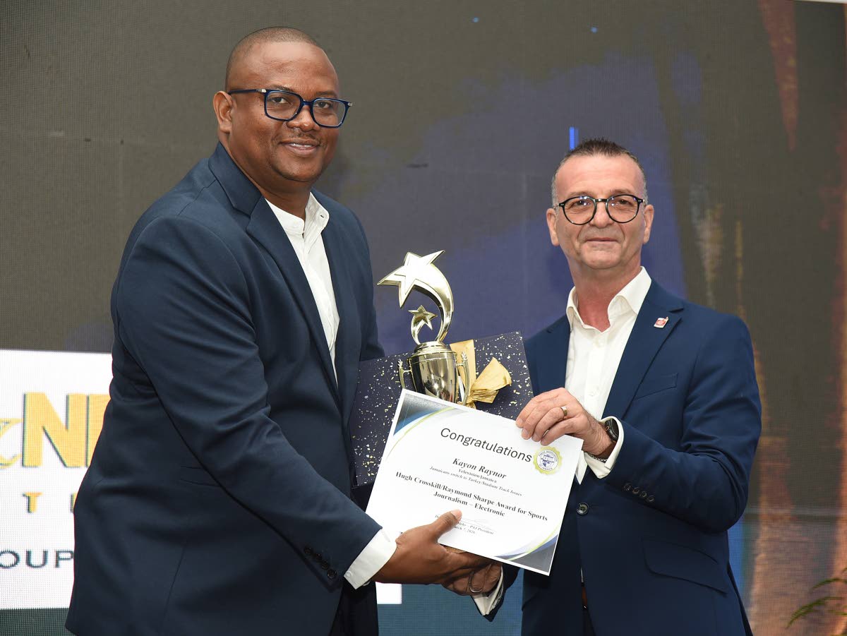 Kayon Raynor (left) from Television Jamaica collects the Hugh Crosskill/Raymond Sharpe Award for Sports Journalism (Electronic) from Daniel Caron, managing director of J Wray and Nephew Limited.