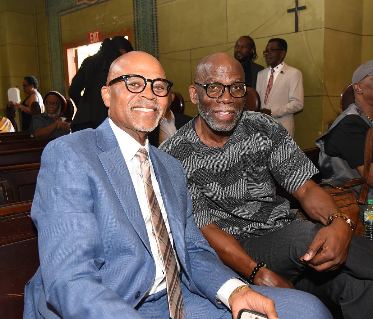 Record producer Donovan Germain (left) and Dr. Dennis Howard were spotted paying their respects.