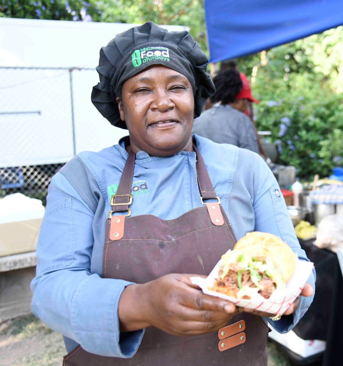 Chef Simone Walker-Barrett of Street Food Saturdays shows off her pulled pork doughnut sandwich.
