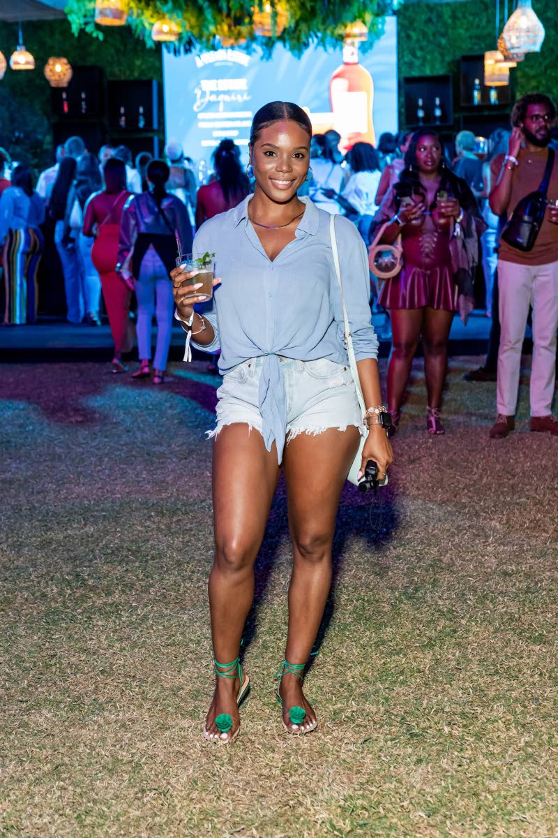 Left: Photographer Monique Thomas switches perspectives at Jamaica Food and Drink Festival’s Decade 2.0, posing for a shot in distressed denim, a front-tie shirt and Bridget Rose sandals. 