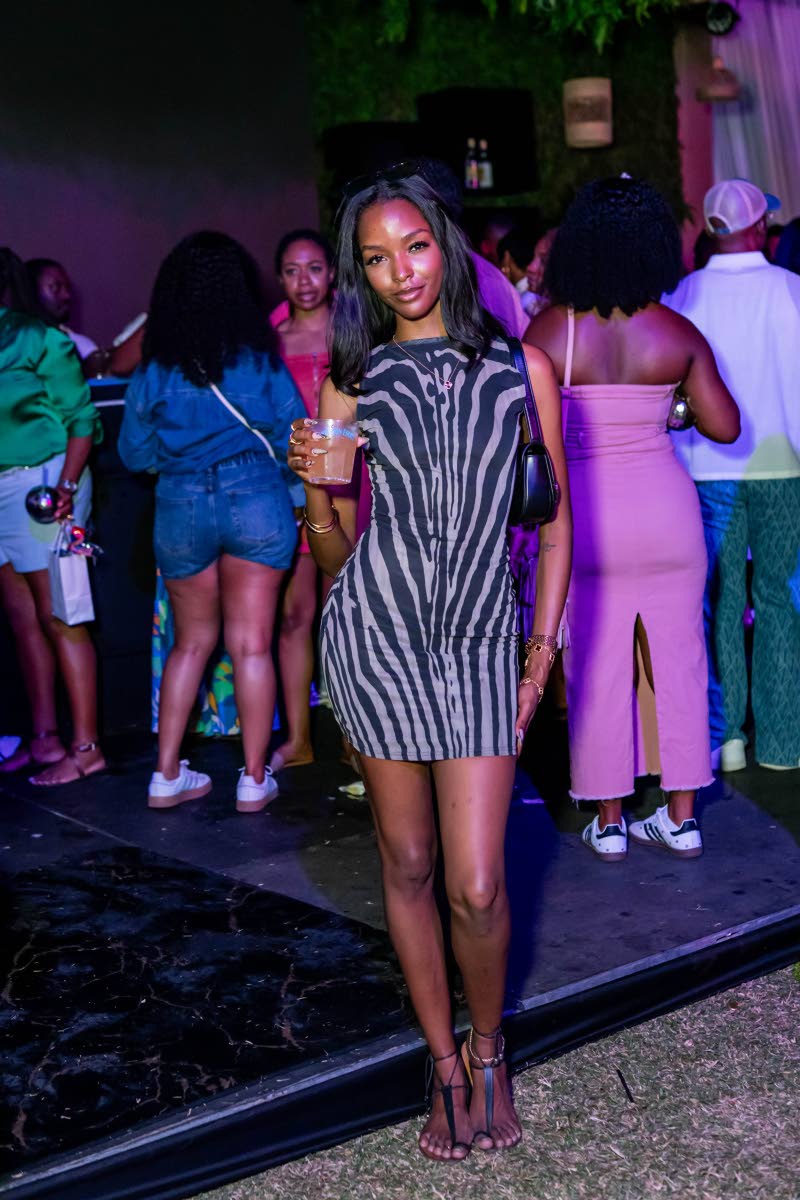 Miqueal-Symone Williams, Miss Universe Jamaica 2020, shows her off-duty model style in a shirt dress, shoulder bag and Bridget Kay Sandals. 