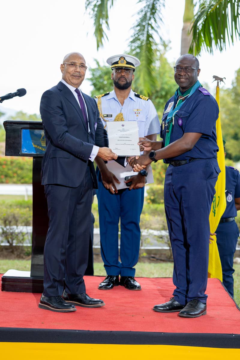 Garth Russell (left), former chief commissioner of the Scout Association of Jamaica, receives his Silver Crocodile Award from Sir Patrick Allen, governor general and chief scout of Jamaica. The award is presented to scouters who have rendered outstanding a
