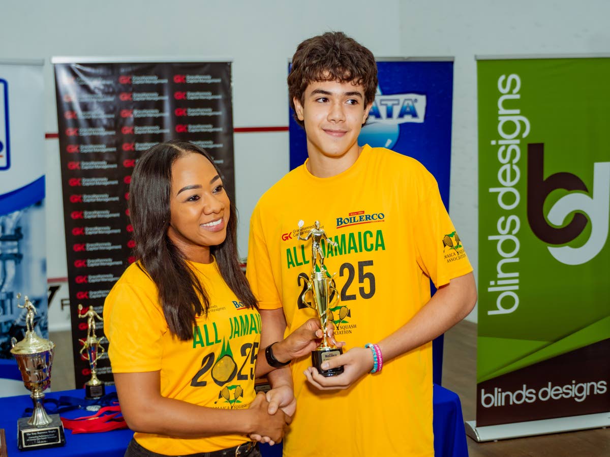 Chanel Simpson (left), head of private wealth at GraceKennedy Capital Management, presents last year’s All Jamaica Squash Championships title to Ethan Miller. 
