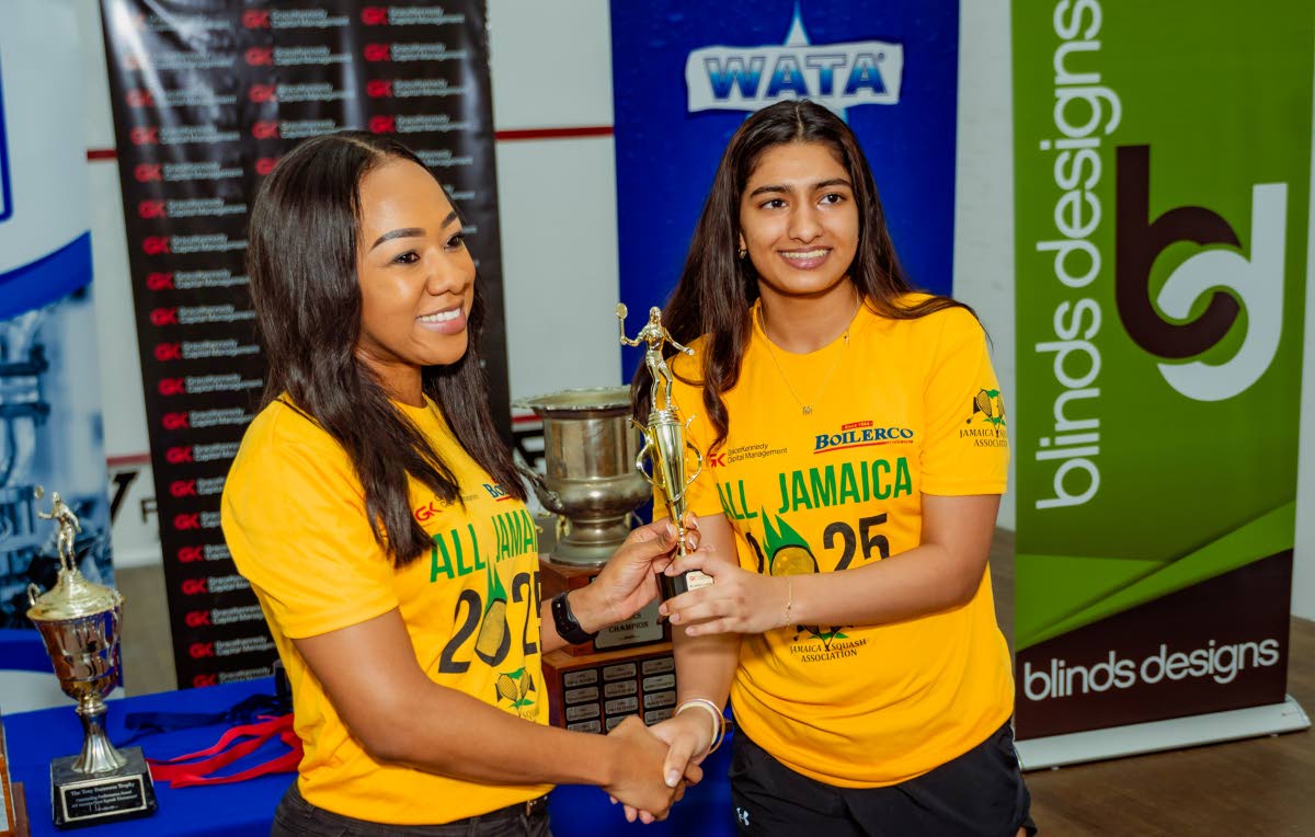 
Chanel Simpson (left ), head of private wealth at GraceKennedy Capital Management, presents last year’s All Jamaica Squash Championships title to Mehar Trehan.